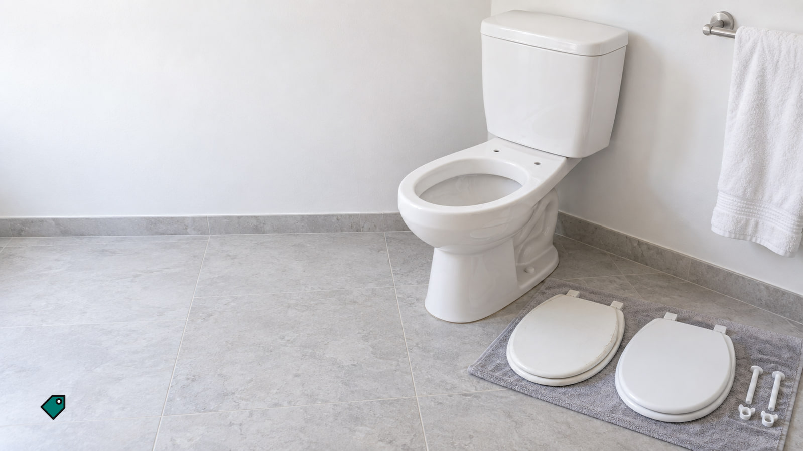 A white toilet without a seat sits in a bright tiled bathroom, with two white toilet seats and loose bolts on a gray mat.