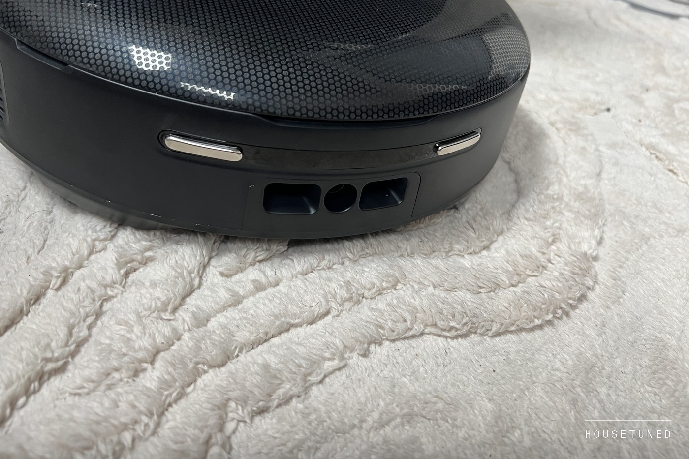 Close view of the front of the M5 Pro on a cream rug, its bumper with two light strips and three openings