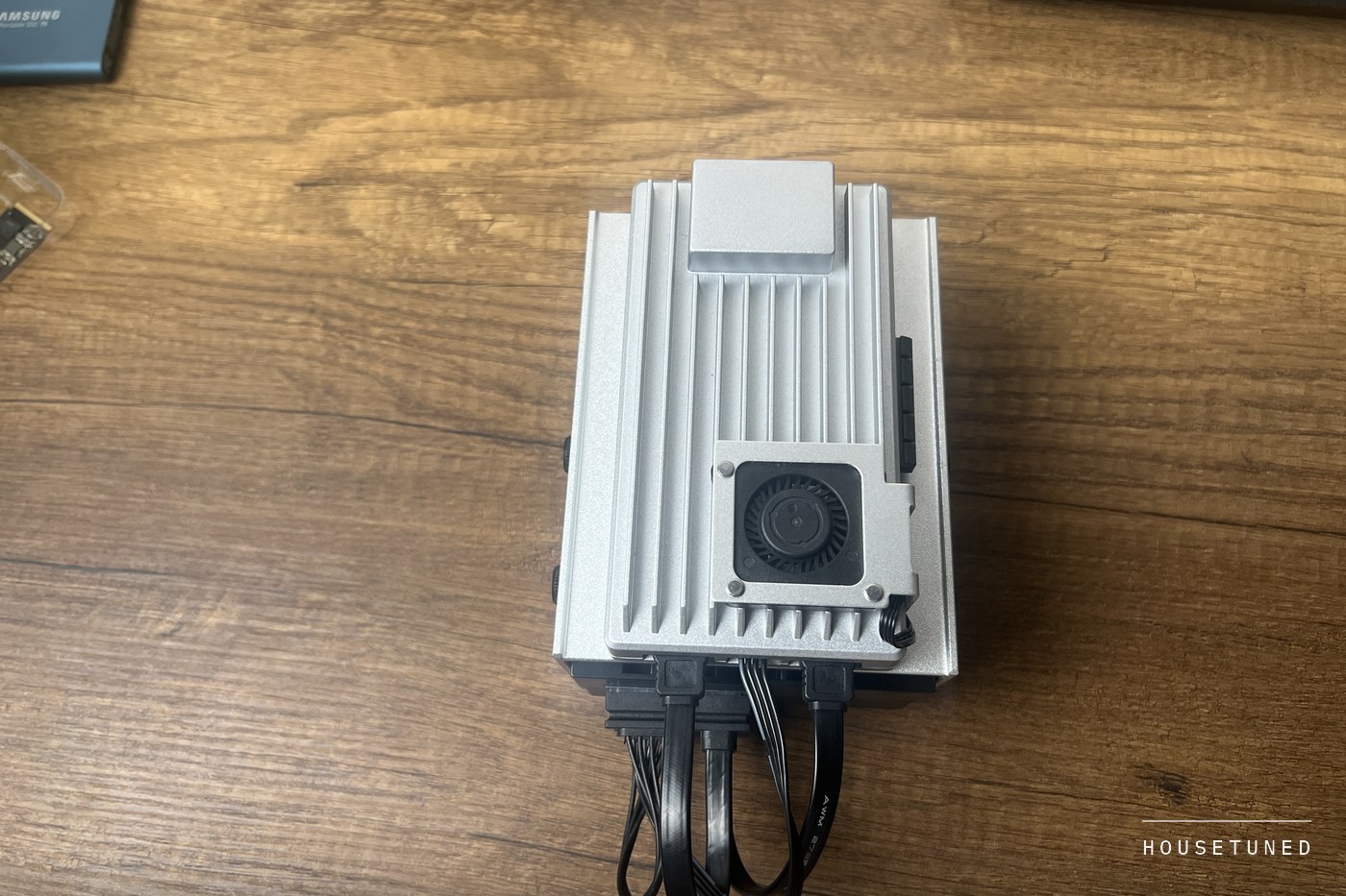Looking down on the finned aluminium lid with the small optional cooling fan bolted into a cutout and its lead running off to one side