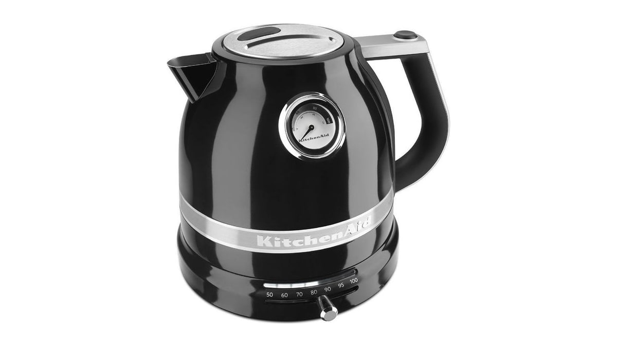 Black KitchenAid electric kettle viewed from the front at an angle, showing its thermometer and temperature control base.