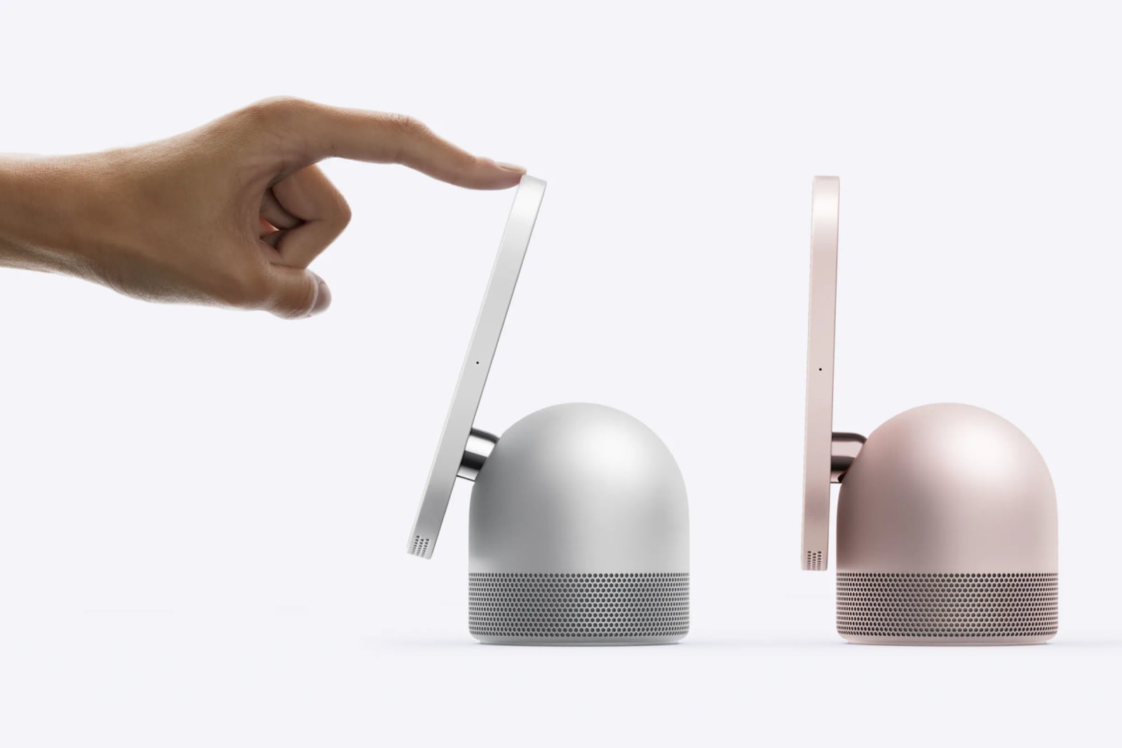 A hand tilts a silver HomeView screen beside a pink HomeView with its screen upright.