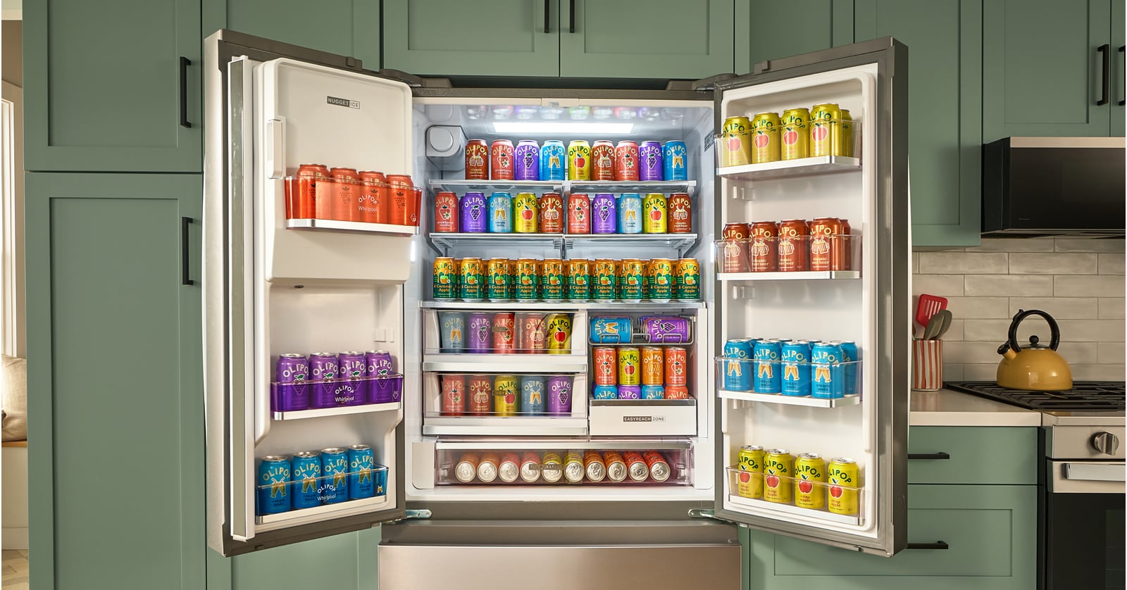 Open refrigerator stocked with OLIPOP cans, branded door bins and a nugget ice compartment, surrounded by green cabinets.